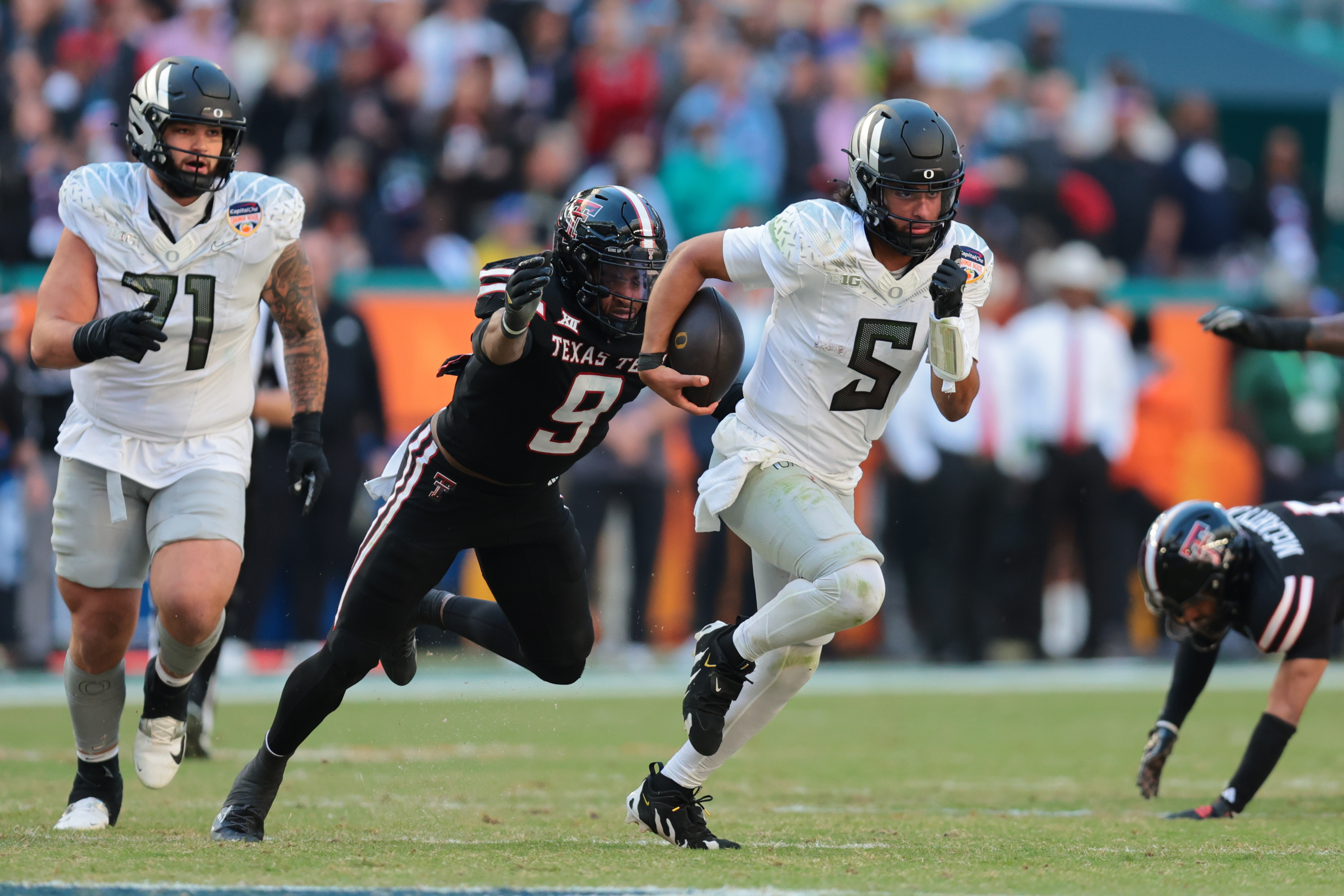 Oregon Ducks quarterback Dante Moore (5), who is featured in the 2026 NFL Draft odds, carries the ball against the Texas Tech Red Raiders.