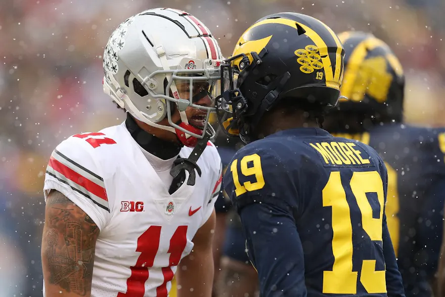 Jaxon Smith-Njigba #11 of the Ohio State Buckeyes and Rod Moore #19 of the Michigan Wolverines talk during the first quarter at Michigan Stadium on Nov. 27, 2021.