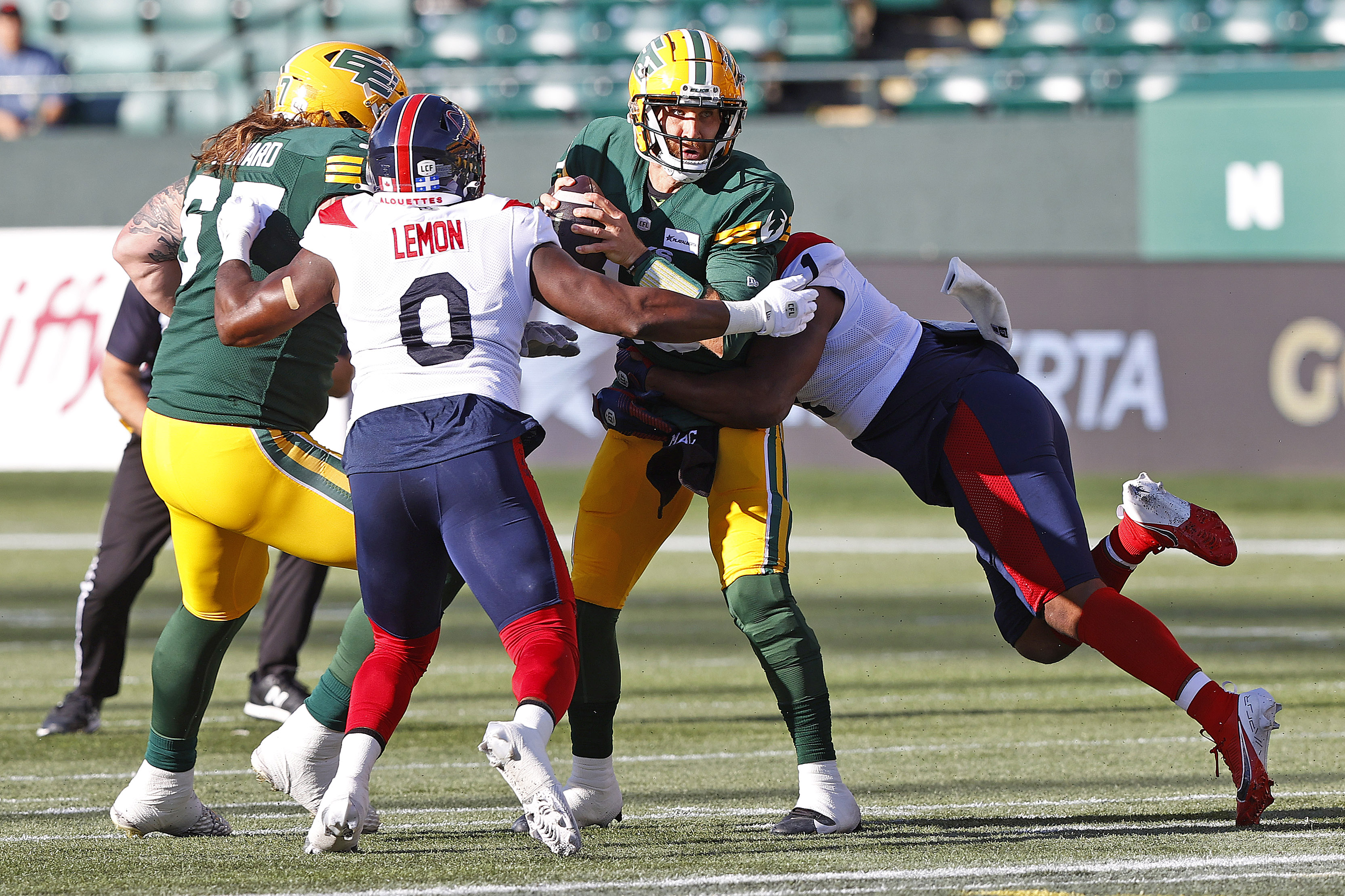 Edmonton Elks quarterback McLeod Bethel-Thompson is tackled by Montreal Alouettes defensive end Shawn Lemon and linebacker Darnell Sankey at Commonwealth Stadium. We're expecting a low-scoring game in our Redblacks vs. Alouettes Prediction. 