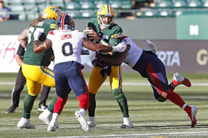 Edmonton Elks quarterback McLeod Bethel-Thompson is tackled by Montreal Alouettes defensive end Shawn Lemon and linebacker Darnell Sankey at Commonwealth Stadium. We're expecting a low-scoring game in our Redblacks vs. Alouettes Prediction. 