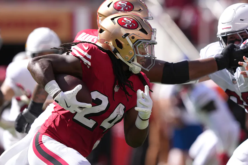 San Francisco 49ers running back Jordan Mason carries the ball against the Arizona Cardinals as we offer our 49ers vs. Seahawks TNF parlay.