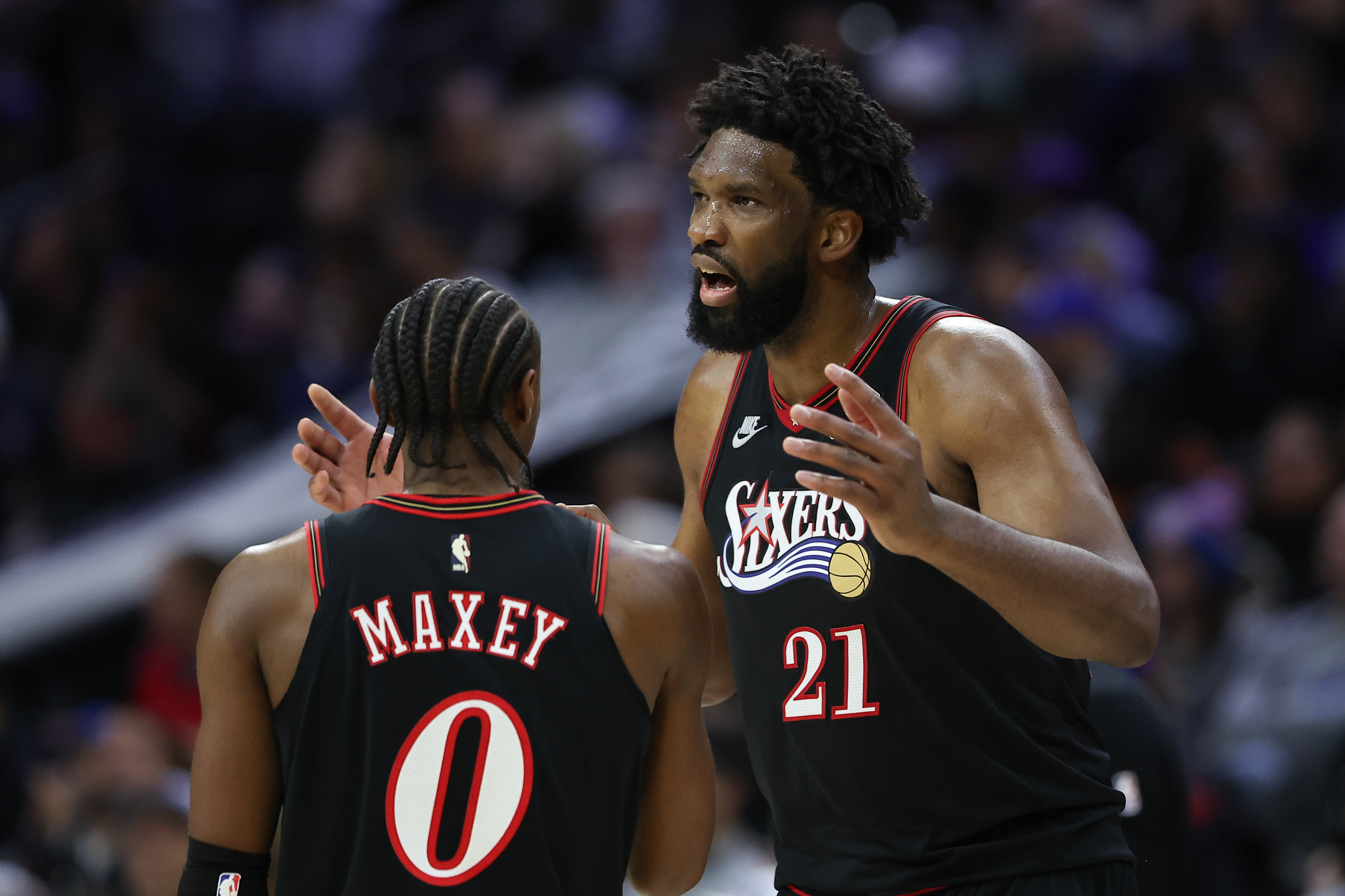 Philadelphia 76ers center Joel Embiid (21) talks with guard Tyrese Maxey, and both are featured in our 76ers vs. Clippers player props.