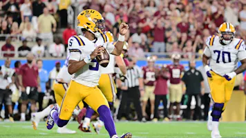 Jayden Daniels of the LSU Tigers scrambles against the Florida State Seminoles as we share our favorite LSU vs. Ole Miss prediction.
