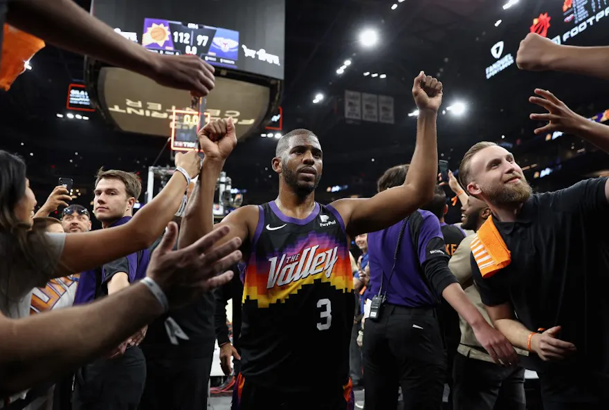Chris Paul of the Phoenix Suns high fives fans after defeating the New Orleans Pelicans at Footprint Center in Phoenix, Arizona. Photo by Christian Petersen/Getty Images via AFP.
