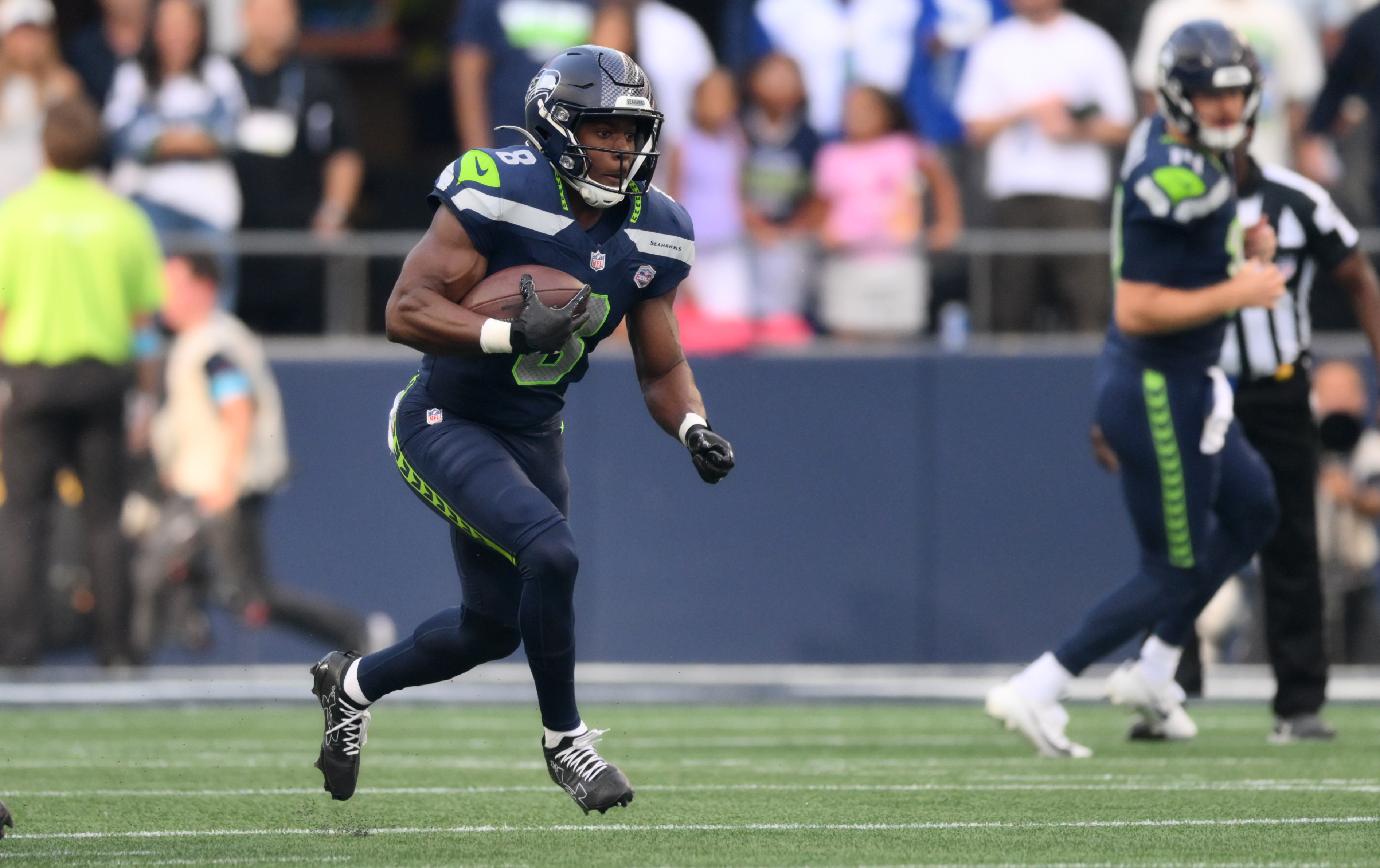 Seattle Seahawks running back Jadarian Price (8) runs as he is featured in our NFL anytime touchdown scorer predictions.