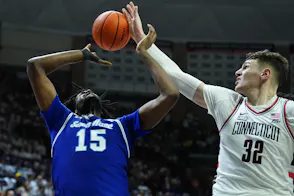 UConn Huskies center Donovan Clingan (32) blocks the shot of Seton Hall Pirates center Jaden Bediako (15), as we examine Connecticut banning Bovada.