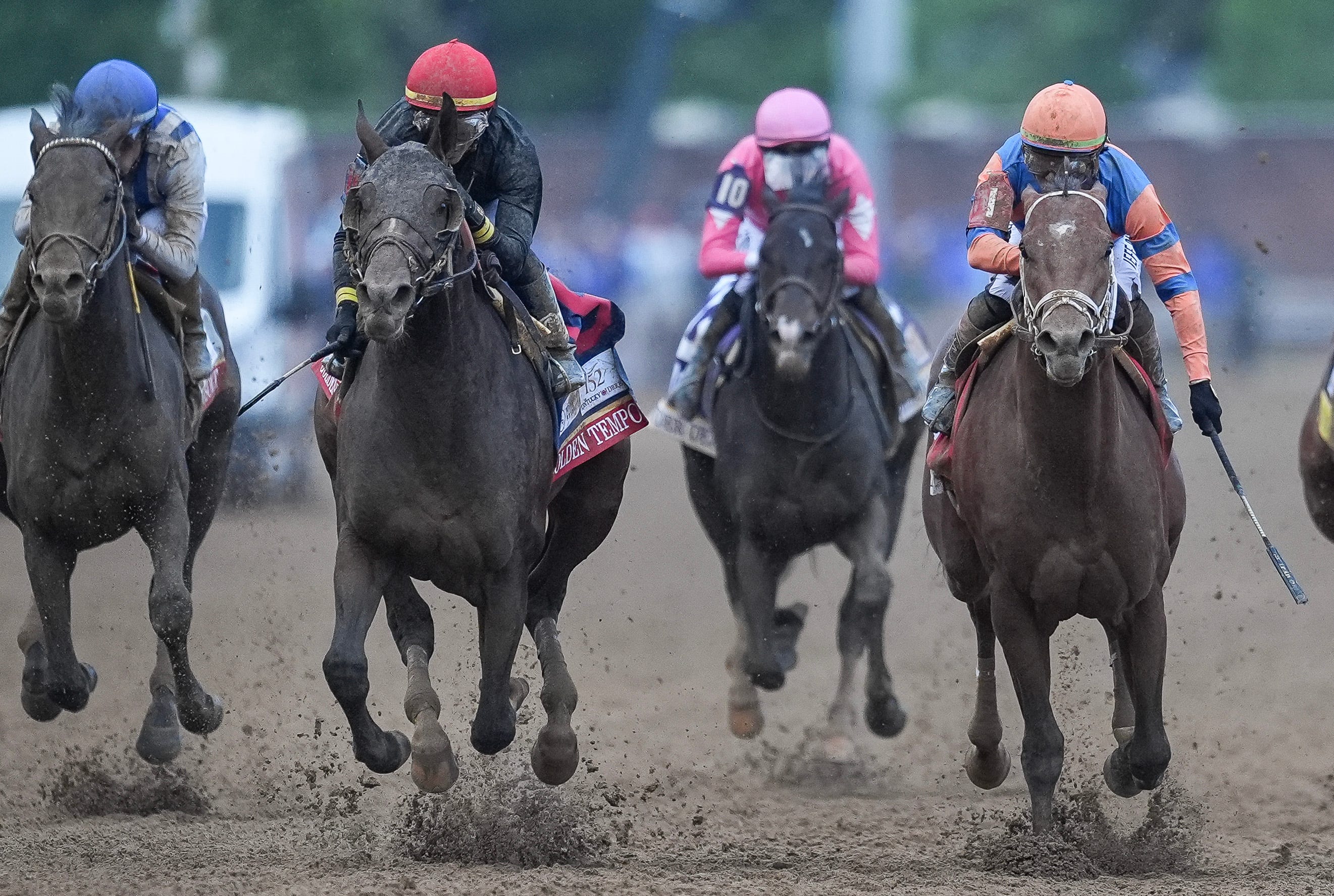 Golden Tempo jockey Jose Ortiz, in a red helmet, comes from the outside to edge Renegade - at right with Irad Ortiz in an orange helmet - and both horses are featured in our Belmont Stakes odds.