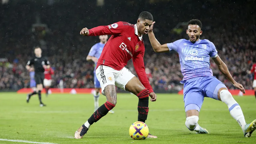 Manchester United forward Marcus Rashford takes on Bournemouth defender Lloyd Kelly during the Premier League match between Manchester United and Bournemouth on Jan. 3, 2023 at Old Trafford in Manchester, England.