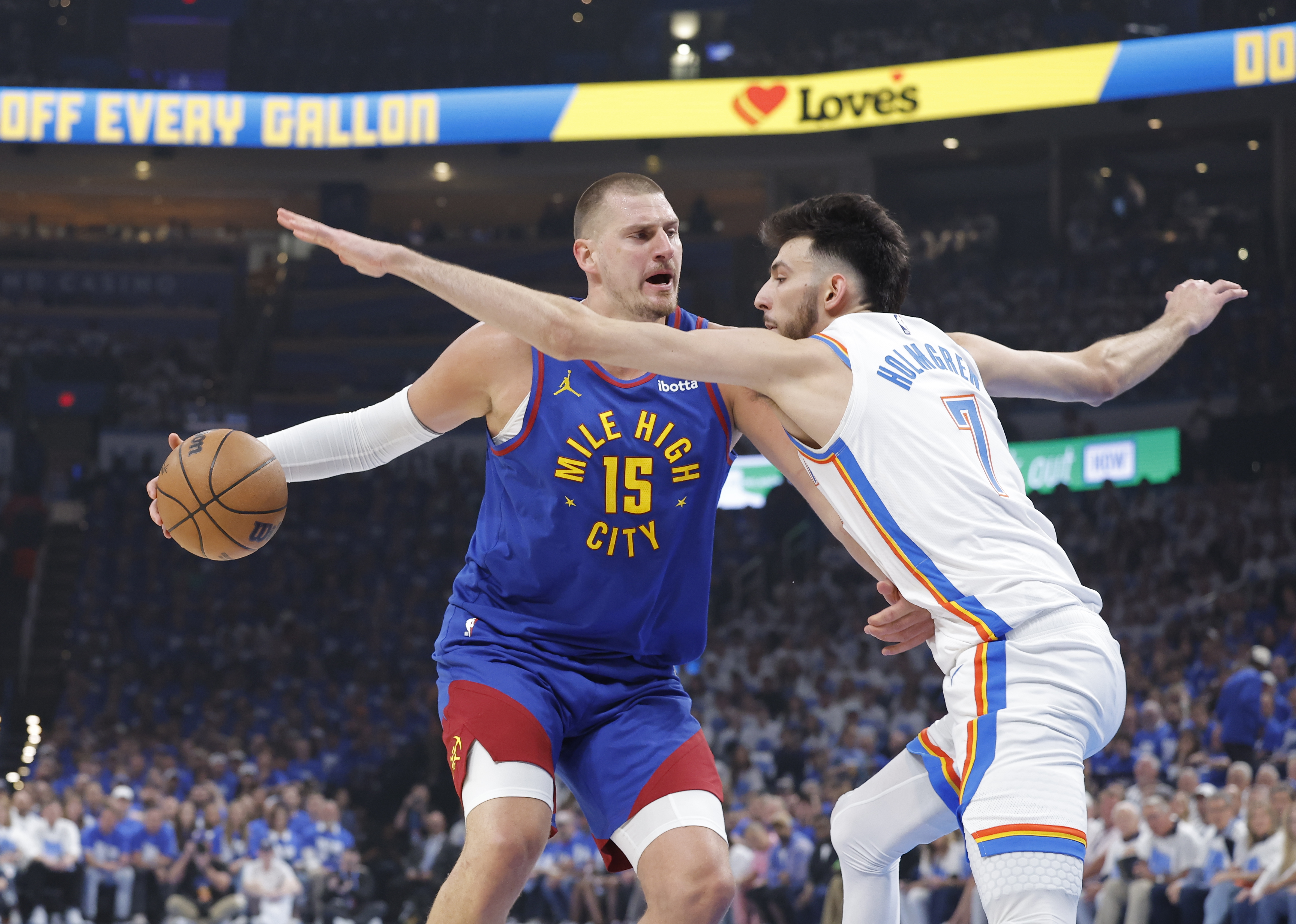 Denver Nuggets center Nikola Jokic (15) is defended by Oklahoma City Thunder forward Chet Holmgren (7) as we provide our Nuggets vs. Thunder prediction.
