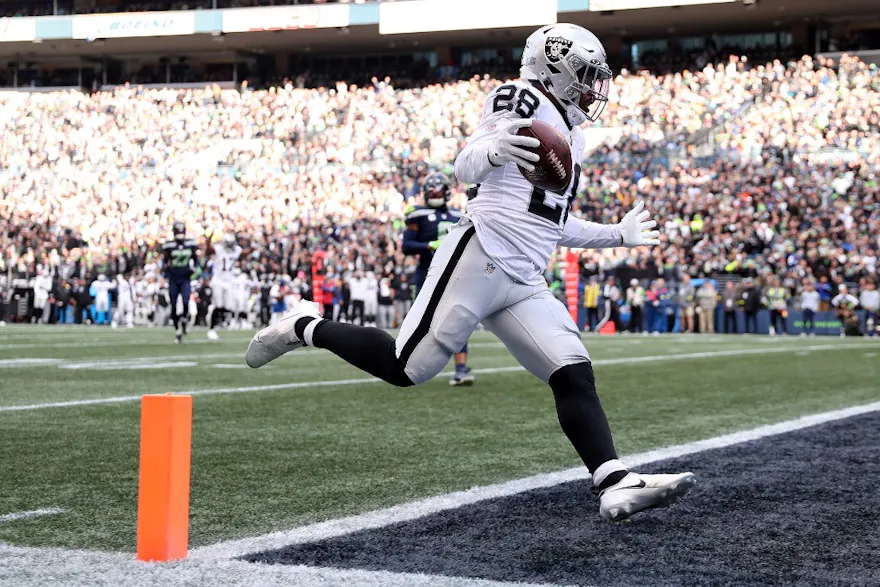Josh Jacobs of the Las Vegas Raiders scores a touchdown against the Seattle Seahawks, and we offer new U.S. bettors our exclusive Caesars promo code for Packers vs. Raiders.