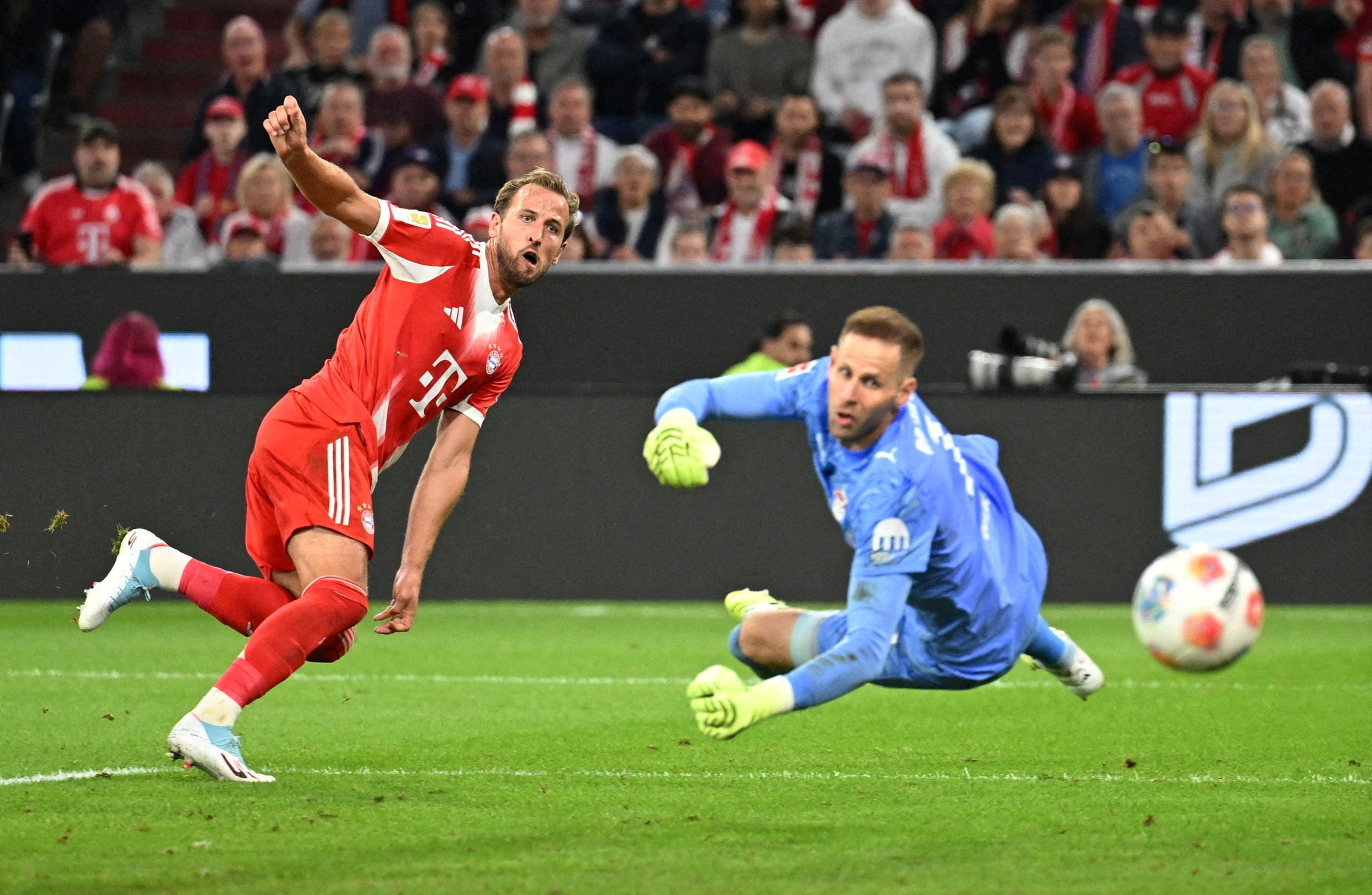 Bayern Munich's Harry Kane scores a goal to complete a hat trick.