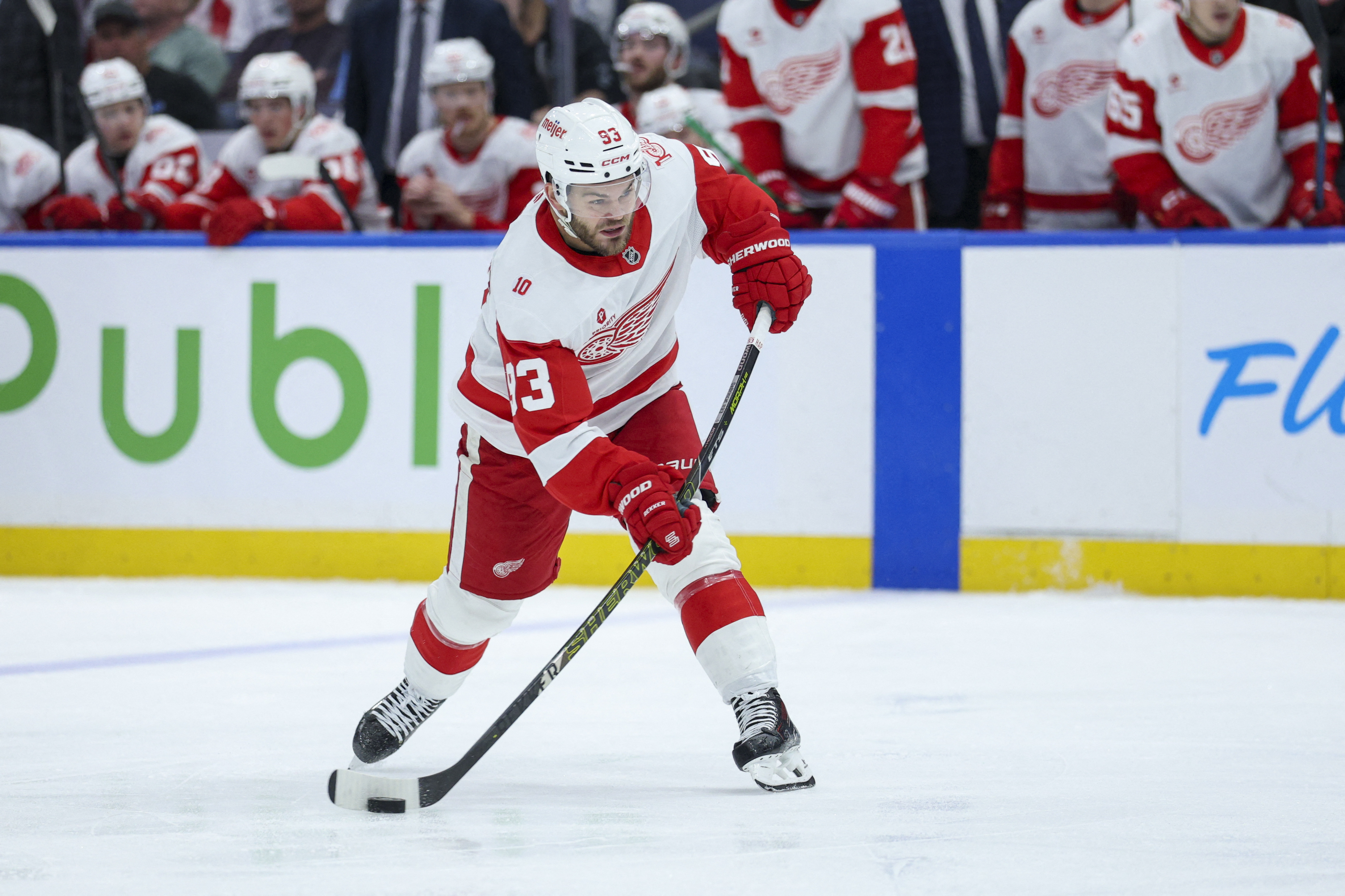 Detroit Red Wings right wing Alex DeBrincat (93) shoots the puck as we break down our Bruins vs. Red Wings prediction & odds.