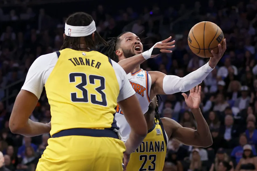 Jalen Brunson (11) of the New York Knicks drives past Myles Turner (33) and Aaron Nesmith (23) of the Indiana Pacers, as we offer our Pacers vs. Knicks player props for Game 2 at Madison Square Garden on Wednesday.