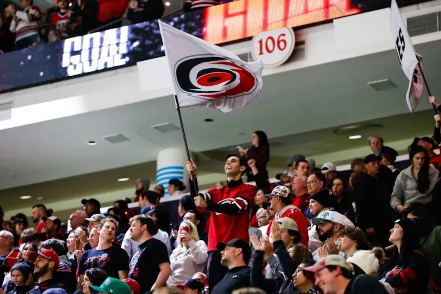 Carolina Hurricanes Storm Crew waves a flag during the third period of a game, and the team has officially partnered with Fanatics Sportsbook.