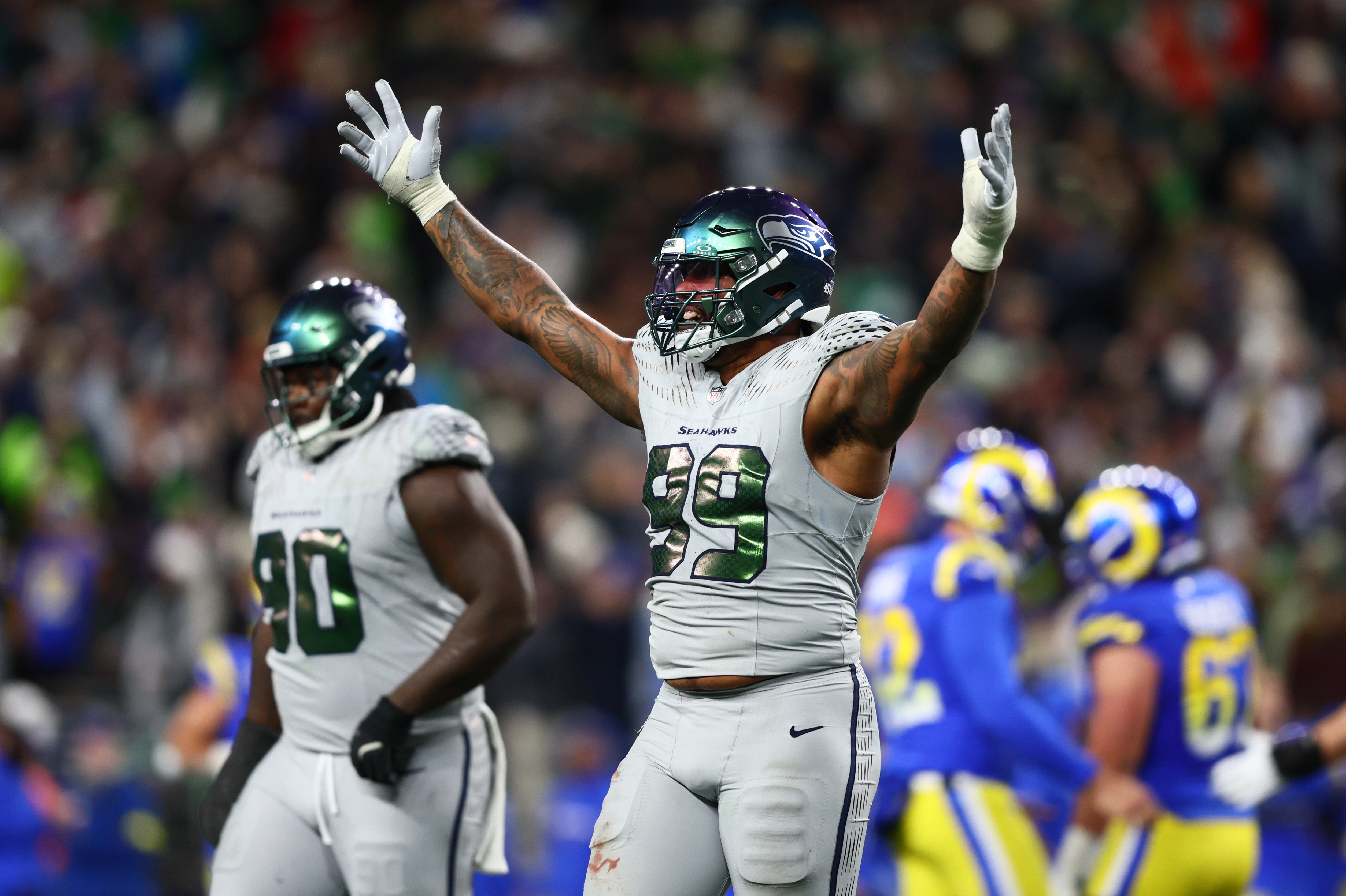 Seattle Seahawks defensive end Leonard Williams (99) reacts as we offer our NFL playoff bracket predictions from Wild Card Weekend to the Super Bowl.