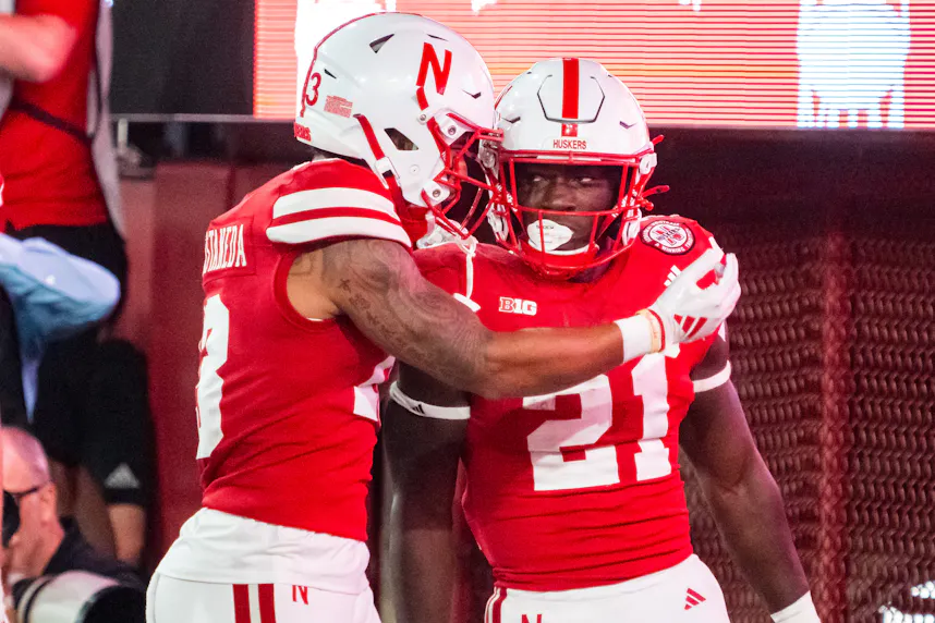 Nebraska Cornhuskers running back Emmett Johnson (21) and wide receiver Isaiah Garcia-Castaneda (13) celebrate as we offer our Illinois vs. Nebraska early predictions and picks for Friday.