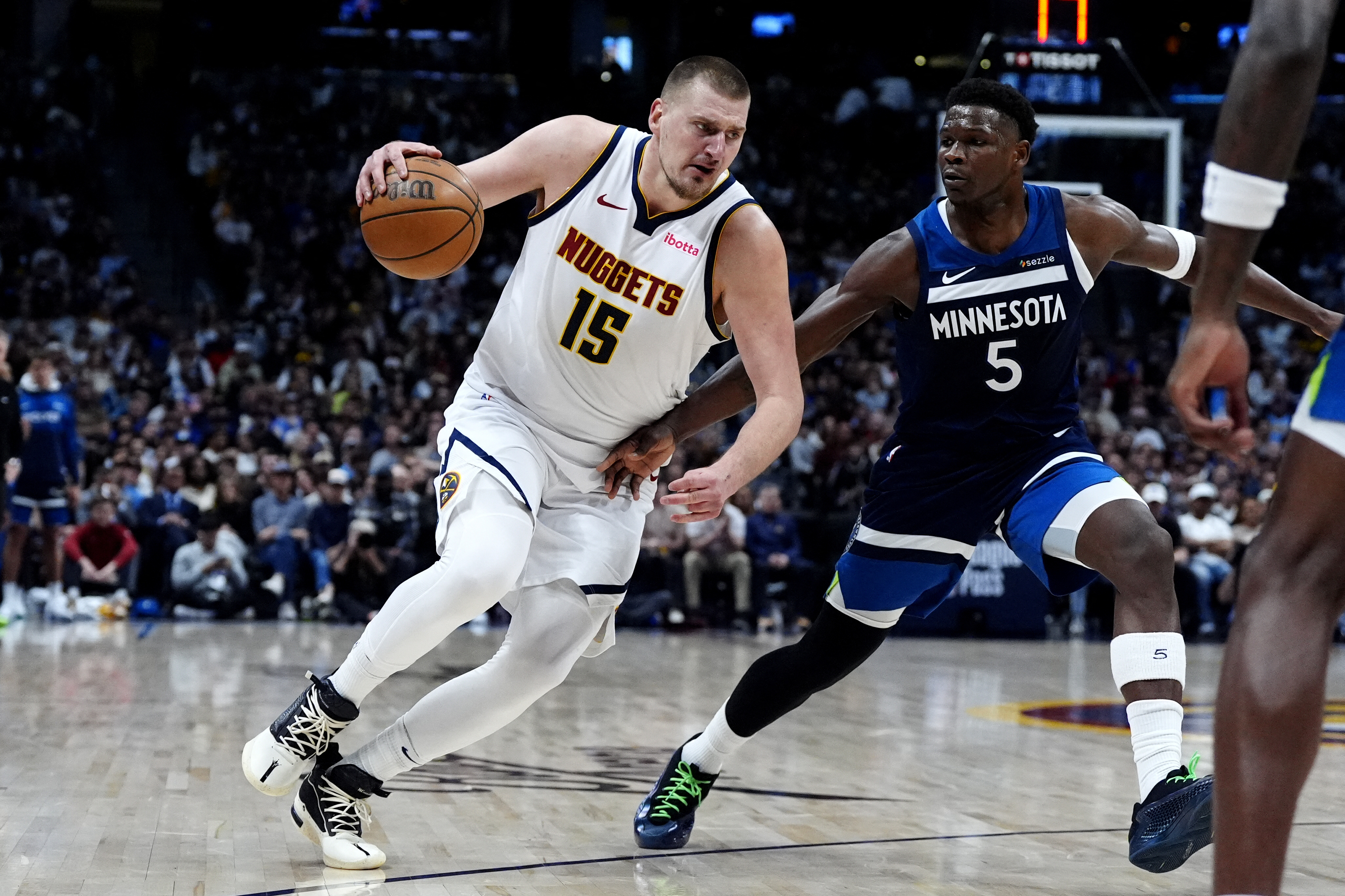 Minnesota Timberwolves guard Anthony Edwards (5) defends Denver Nuggets center Nikola Jokic (15) as we offer our Timberwolves vs. Nuggets player props today.
