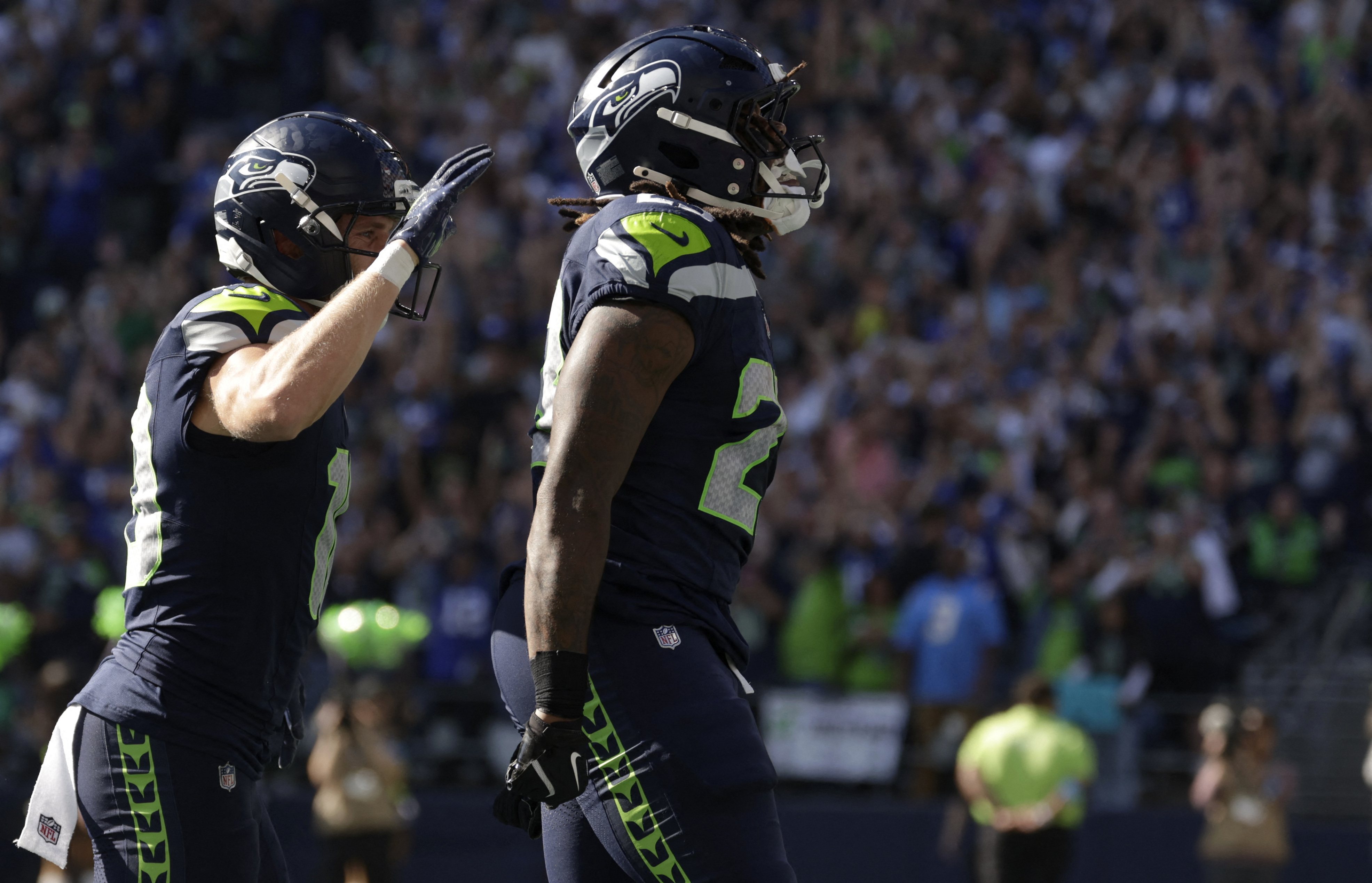 Seattle Seahawks running back Emanuel Wilson (23) celebrates after running for a touchdown as he is featured in our Seahawks vs. Broncos touchdown scorer pick.