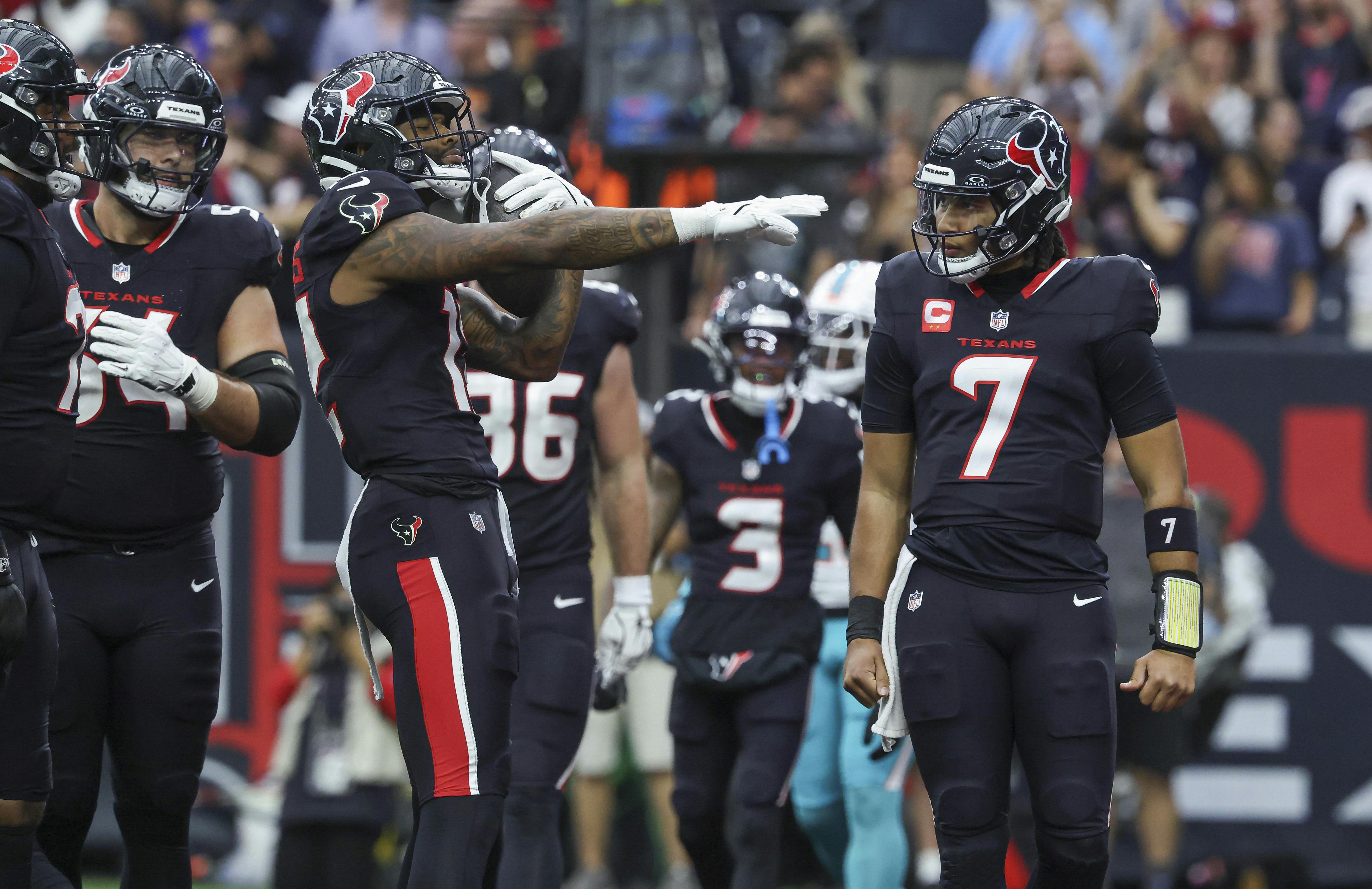 Houston Texans wide receiver Nico Collins (12) celebrates with quarterback C.J. Stroud (7) after a touchdown as we look at our Wild Card Weekend best bets.