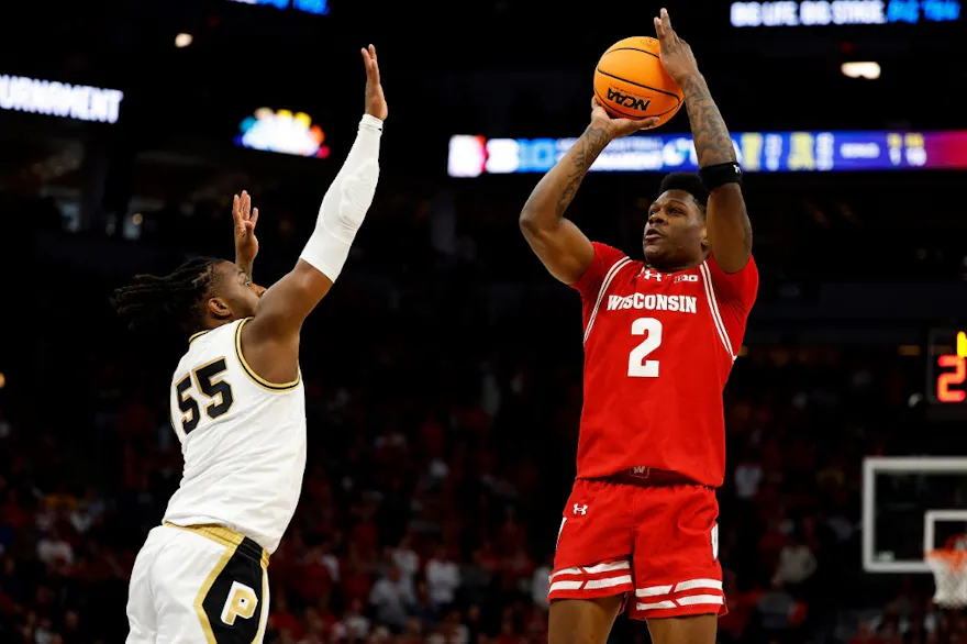 AJ Storr of the Wisconsin Badgers shoots the ball against Lance Jones of the Purdue Boilermakers during overtime of the Big Ten Tournament. We're backing Wisconsin in our college basketball player props and best bets. 