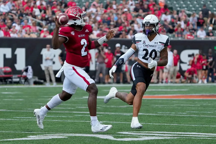 Aveon Smith of the Miami (OH) RedHawks throws a pass while Deshawn Pace of the Cincinnati Bearcats defends at Paycor Stadium on Sept. 17, 2022 in Cincinnati, Ohio.
