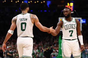 Jaylen Brown (7) of the Boston Celtics celebrates with Jayson Tatum (0), as we round up the 2024 NBA Finals consensus picks and expert predictions ahead of Game 1 on Thursday at TD Garden in Boston.