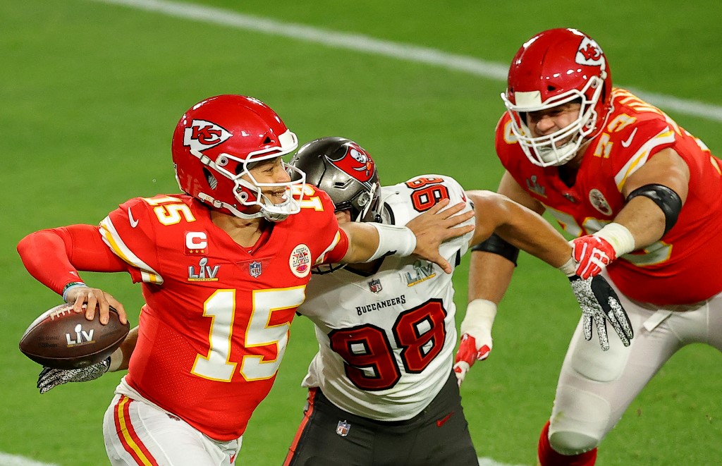 Kansas City Chiefs' quarterback Patrick Mahomes evades pressure as we rank the best Super Bowl performances from Mahomes ahead of Super Bowl 58. 