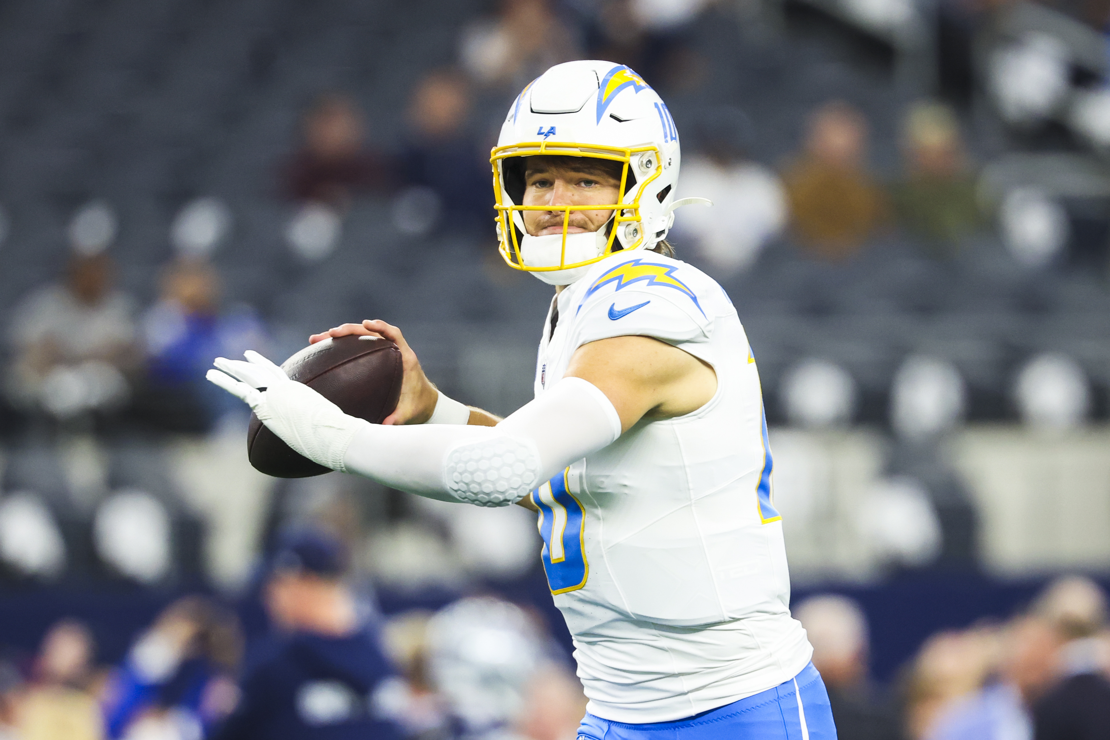 Los Angeles Chargers quarterback Justin Herbert (10) warms up as we offer our NFL picks against the spread for Week 17.