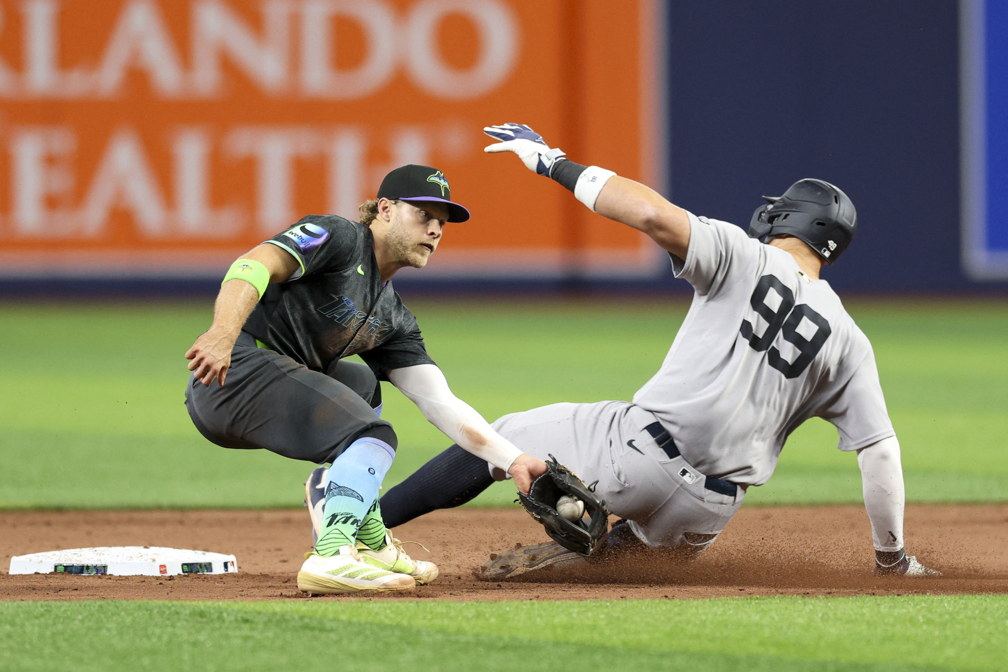 Yankees outfielder Aaron Judge steals second base past Rays shortstop Taylor Walls as we make our best Yankees vs. Rays prediction.