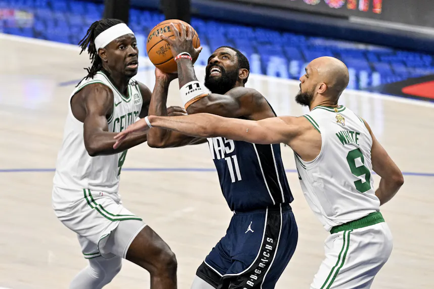 Dallas Mavericks guard Kyrie Irving drives to the basket between Boston Celtics guard Jrue Holiday and guard Derrick White during Game 4 of the 2024 NBA Finals. We're backing White in our Mavericks vs. Celtics Parlay.