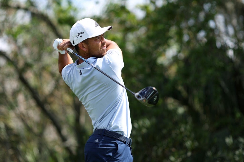 Xander Schauffele hits a shot in a practice round as we look at the best Players Championship odds boosts.