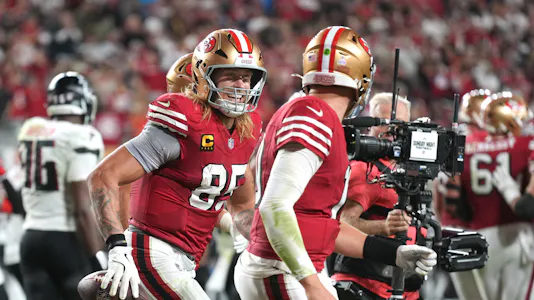 San Francisco 49ers tight end George Kittle (center left) celebrates with quarterback Mac Jones (center right) after a touchdown as we look at our National Tight Ends Day anytime touchdown scorer predictions