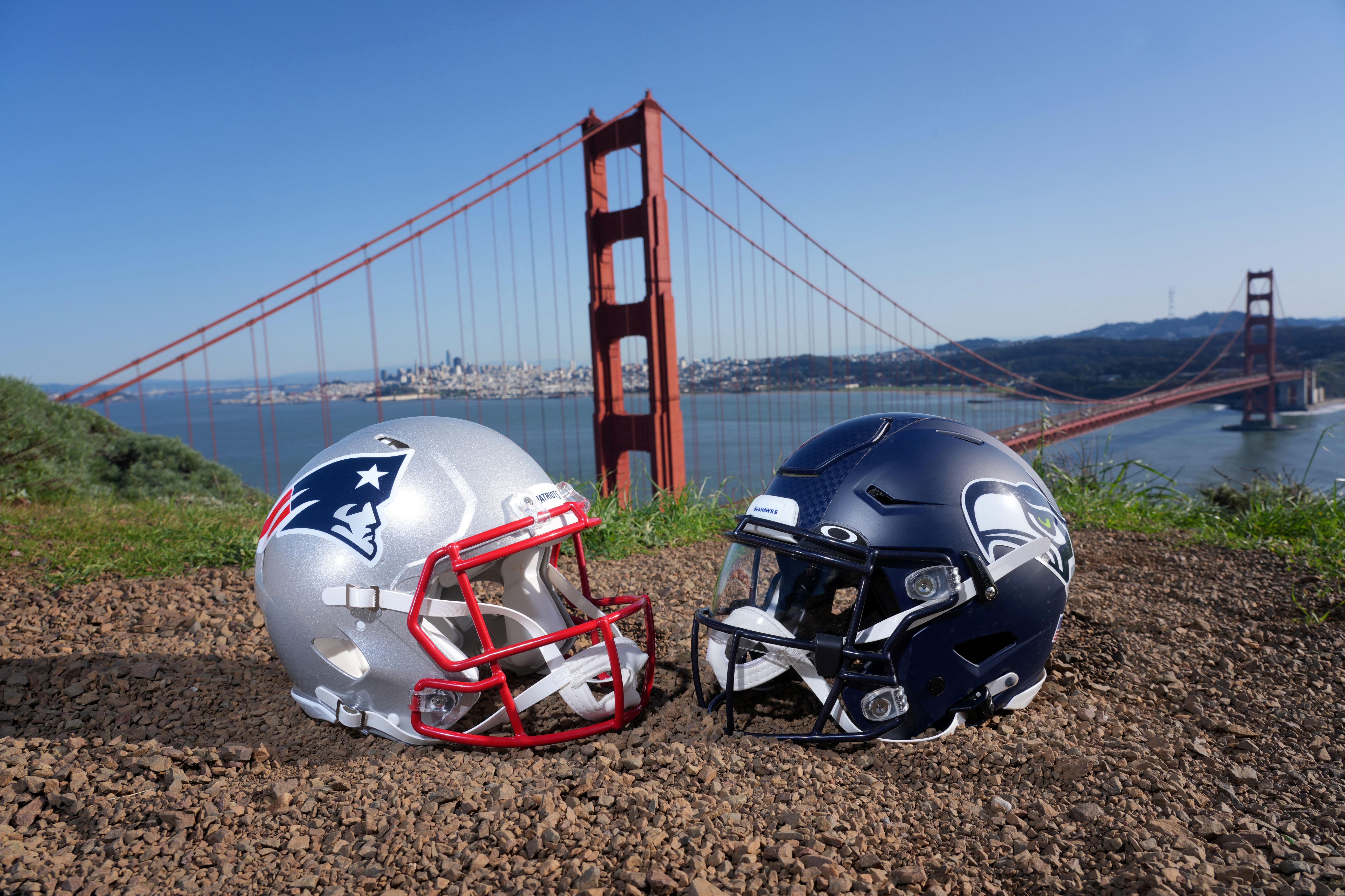 New England Patriots and Seattle Seahawks helmets with the Golden Gate bridge as a backdrop.