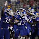 Eriq Gilyard #13 of the Kansas Jayhawks is congratulated by Zion DeBose #35 and Shaad Dabney #16 after intercepting a pass against the Tennessee Tech Golden Eagles in the second half at David Booth Kansas Memorial Stadium on Sept. 2.
