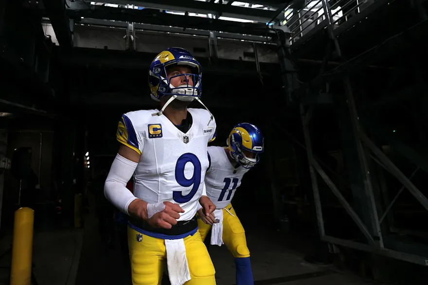 Matthew Stafford #9 and Carson Wentz #11 of the Los Angeles Rams run onto the field prior to a game as we make our Rams vs. Lions player props picks and predictions ahead of Sunday's playoff matchup on NFL Wild Card Weekend.