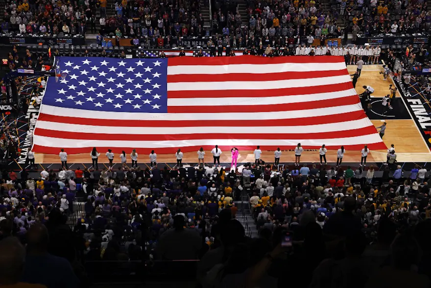 The American flag covers the court during the singing of the national anthem prior to the game between the LSU Lady Tigers and Iowa Hawkeyes.
