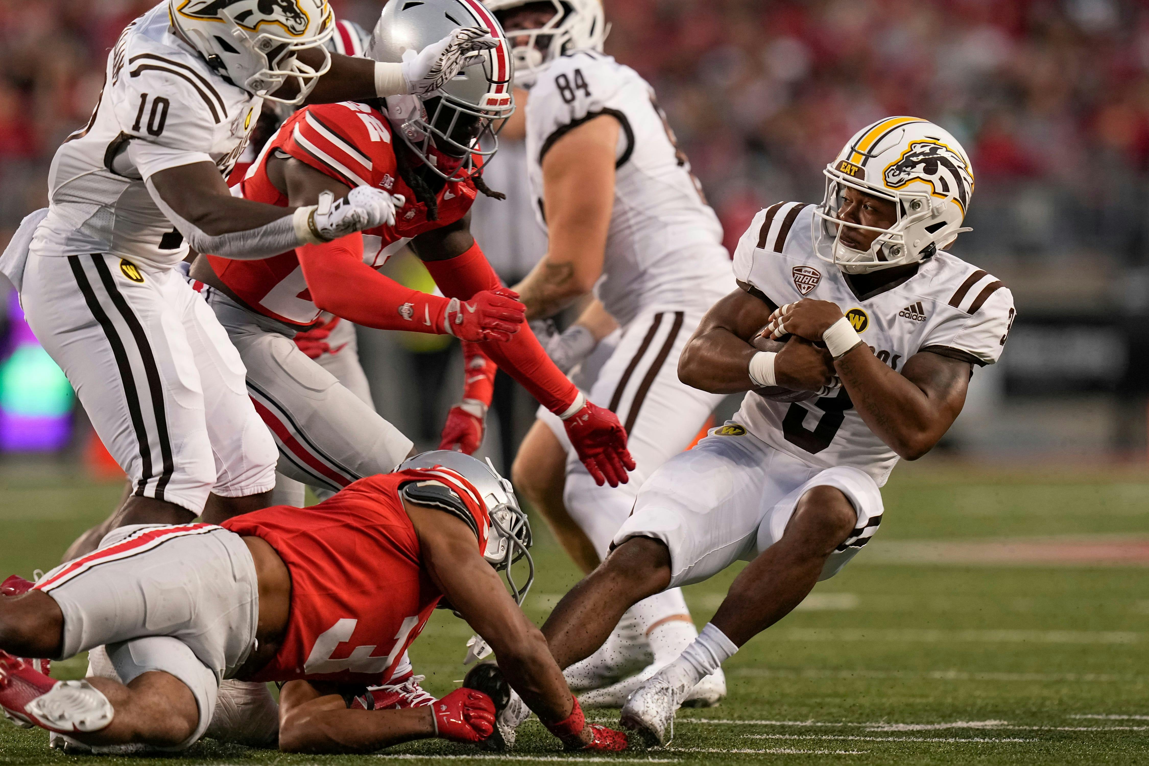 Western Michigan running back Jaden Nixon is tackled by Ohio State cornerback Lorenzo Styles Jr. WMU is part of our Week 13 college football predictions. 