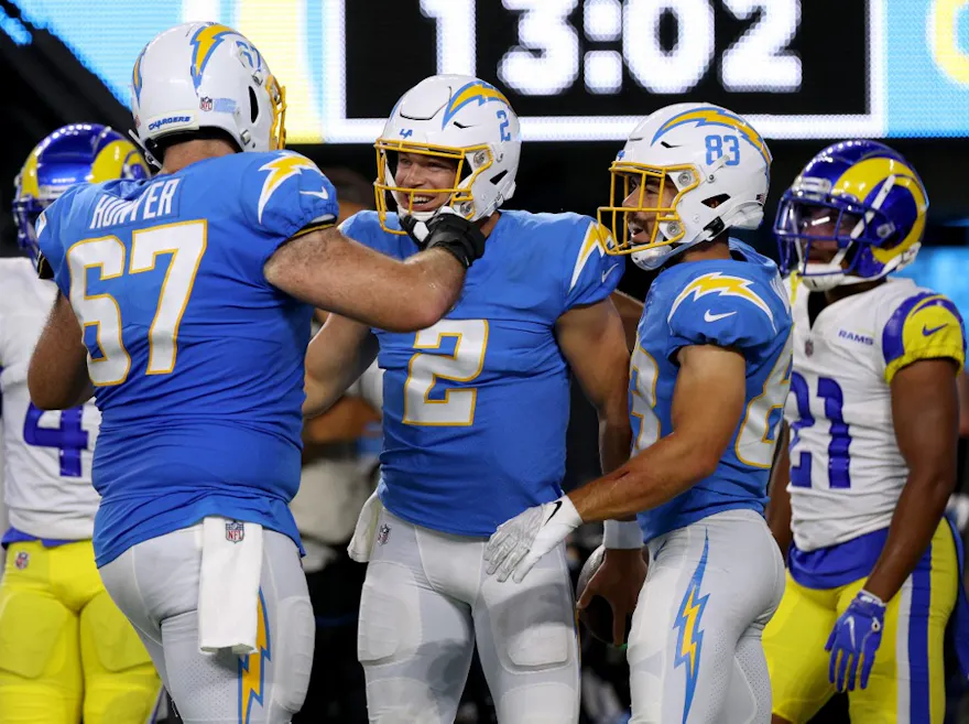 Quarterback Easton Stick of the Los Angeles Chargers celebrates his touchdown run with Ryan Hunter and Michael Bandy. Photo by Harry How/Getty Images via AF