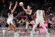 Caitlin Clark of the Indiana Fever passes the ball while being guarded by Betnijah Laney-Hamilton and Jonquel Jones of the New York Liberty. We're focusing on Clark in our Fever vs. Liberty Odds, WNBA Picks. 
