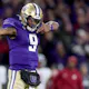 Michael Penix Jr. of the Washington Huskies reacts after a first down against the Washington State Cougars during the fourth quarter as we look at the Caesars promo code for the College Football Playoff.