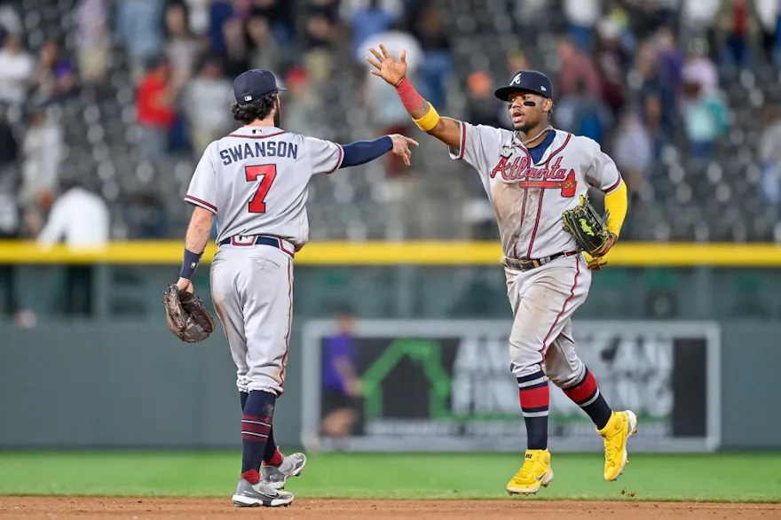 Ronald Acuna Jr. and Dansby Swanson of the Atlanta Braves celebrate after a win against the Colorado Rockies at Coors Field.