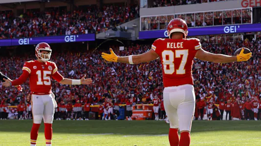 Tight end Travis Kelce #87 of the Kansas City Chiefs celebrates with quarterback Patrick Mahomes #15 after catching a second-quarter touchdown pass against the Cincinnati Bengals in the AFC Championship Game at Arrowhead Stadium on Jan. 30.