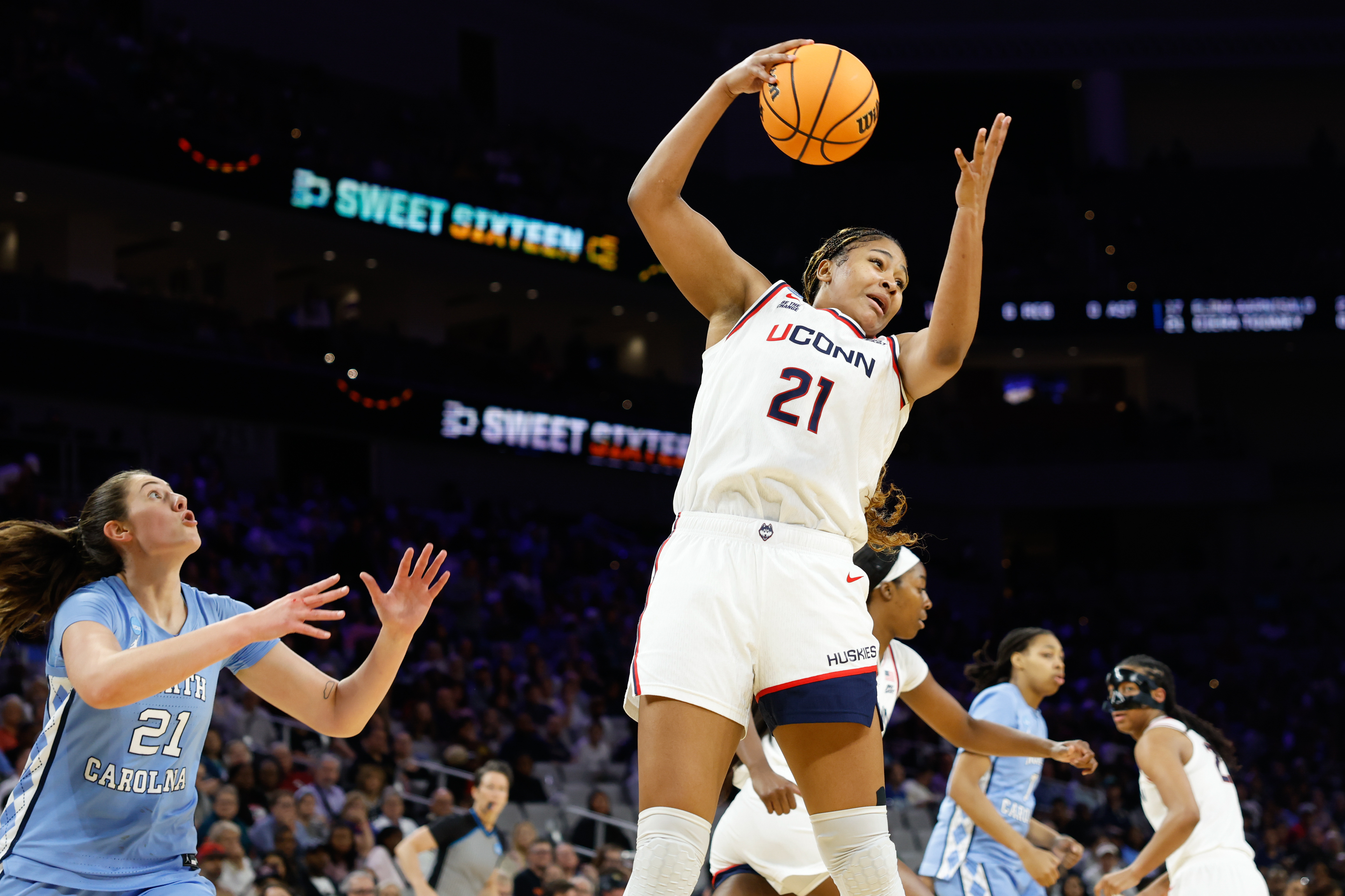 UConn Huskies forward Sarah Strong (21) rebounds as we break down our South Carolina vs. UConn prediction.