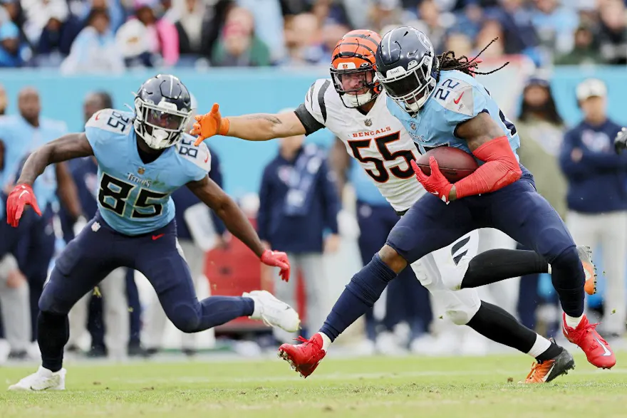 Derrick Henry of the Tennessee Titans runs with the ball as Logan Wilson of the Cincinnati Bengals defends during a game at Nissan Stadium on November 27, 2022 in Nashville, Tennessee.