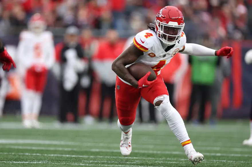 Rashee Rice of the Kansas City Chiefs runs the ball ahead of our Week 16 NFL predictions for Raiders vs. Chiefs 