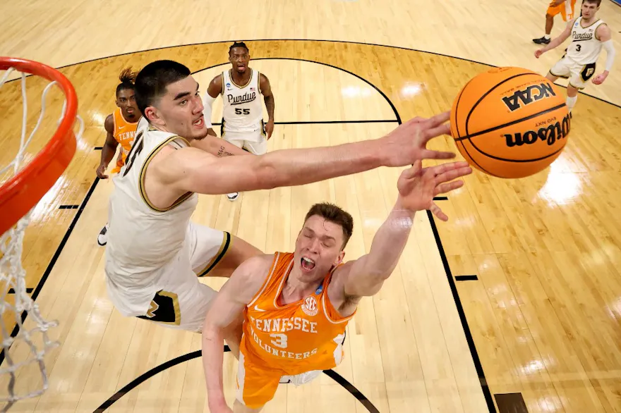 Zach Edey of the Purdue Boilermakers blocks a shot by Dalton Knecht of the Tennessee Volunteers during the Elite Eight round of the NCAA Men's Basketball Tournament. We're backing Edey in our men's Final Four expert picks.