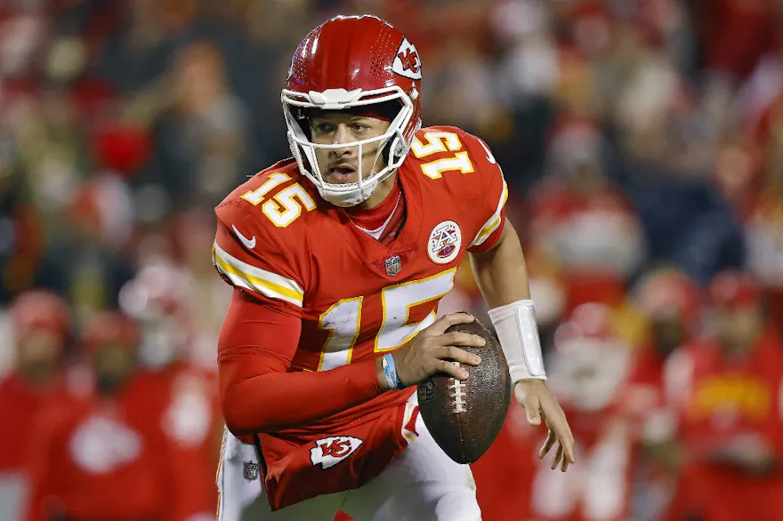 Patrick Mahomes of the Kansas City Chiefs runs with the ball during the second half against the Los Angeles Rams, and we offer our top Eagles vs. Chiefs predictions based on the best NFL odds.