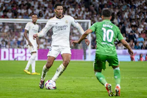 Jude Bellingham is in action with the ball against Ayoze Perez of Real Betis as Gary Pearson looks at the best prop pick and prediction for the June 1 Champions League final between Real Madrid and Borussia Dortmund. 