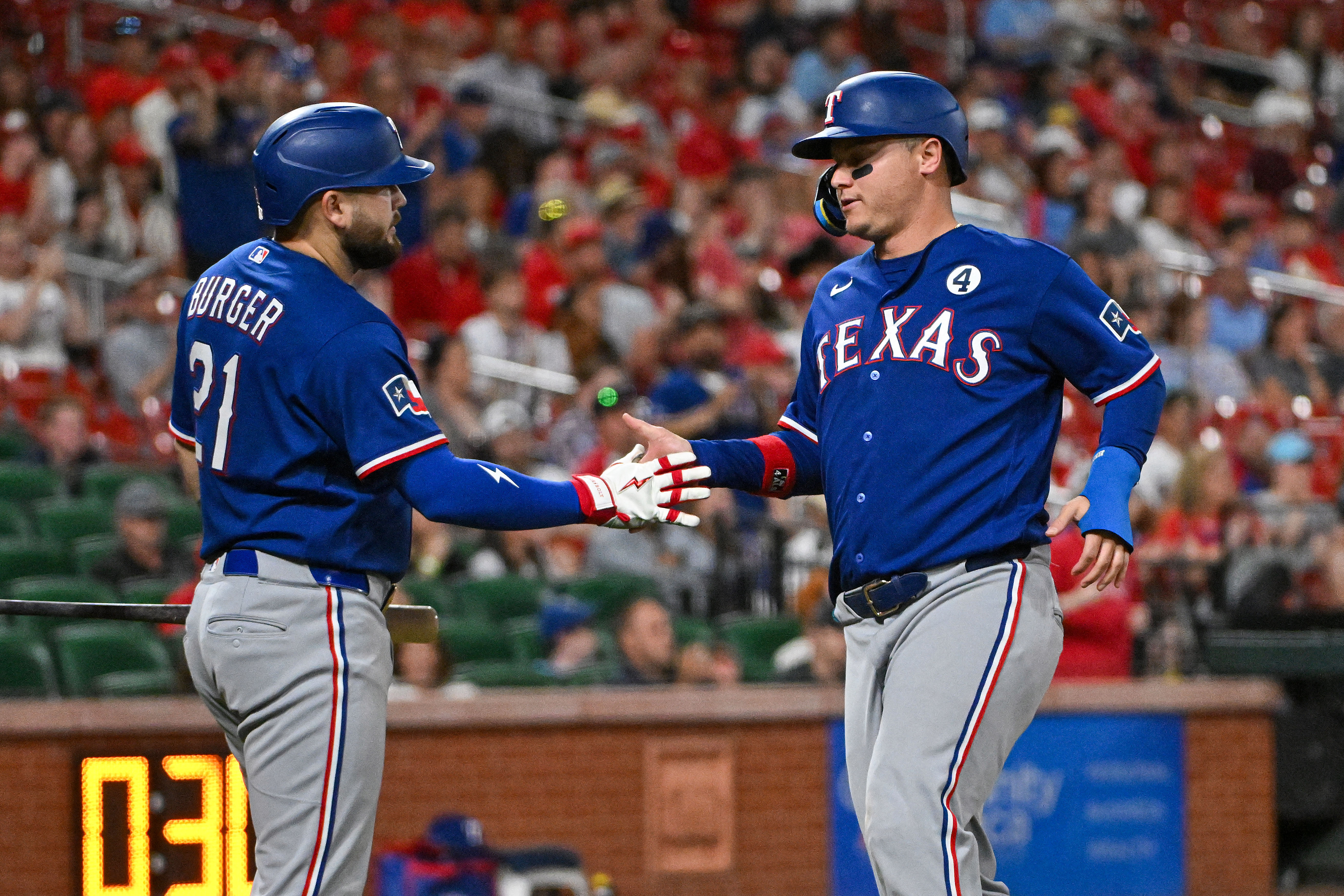 Texas Rangers designated hitter Joc Pederson (3) is congratulated by first baseman Jake Burger (21) as he is featured in our Rangers vs. Cardinals prediction.