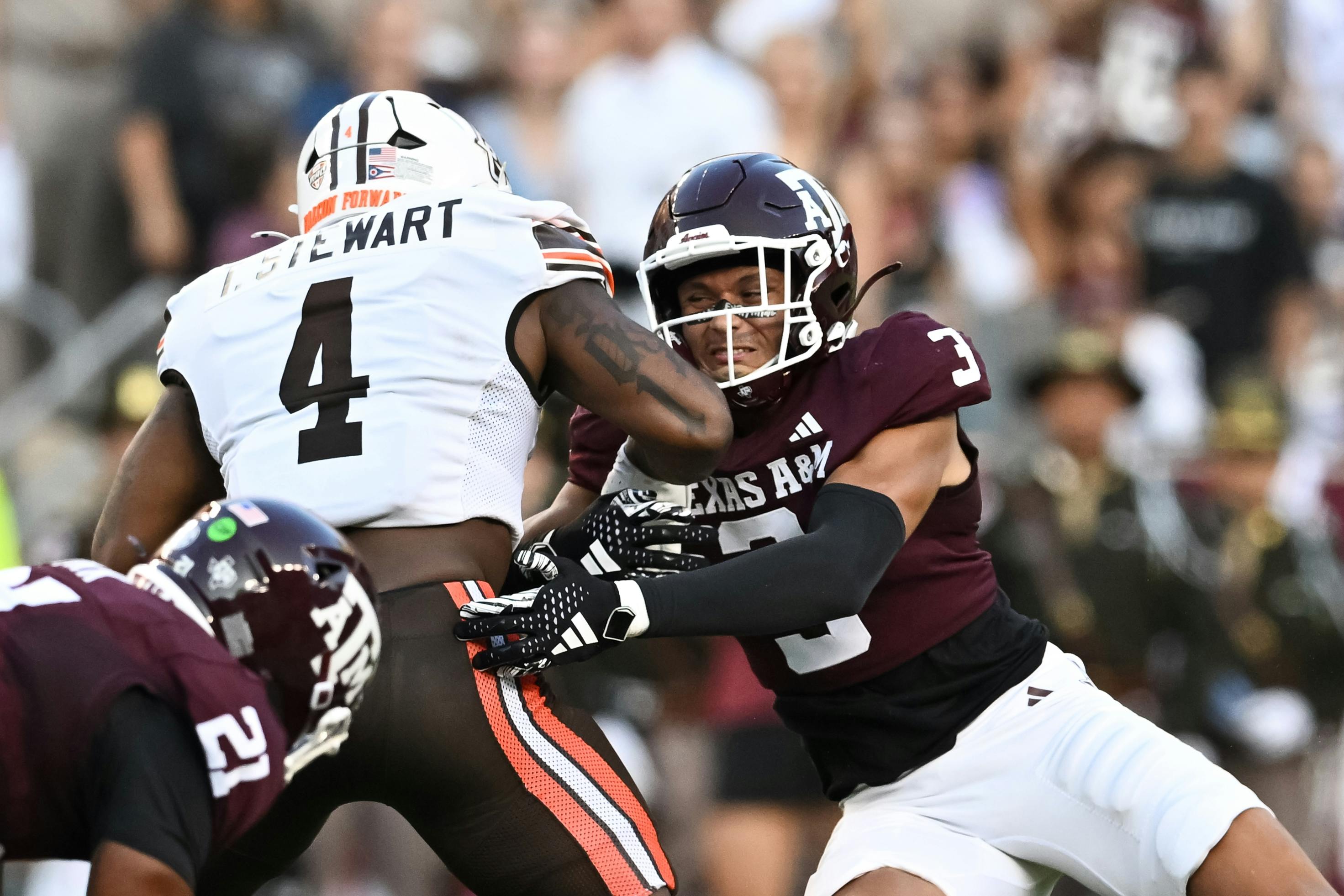 Texas A&M defensive back Marcus Ratcliffe tackles Bowling Green running back Terion Stewart. Bowling Green leads the MAC Championship odds. 